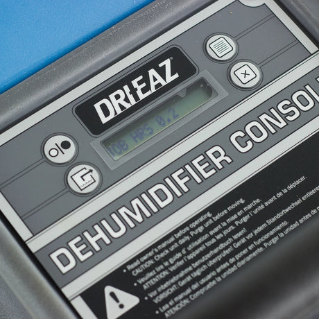 Close-up of a Dri-Eaz dehumidifier console with control buttons and display.