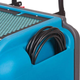 Blue and gray industrial dehumidifier with coiled black cable on a white background