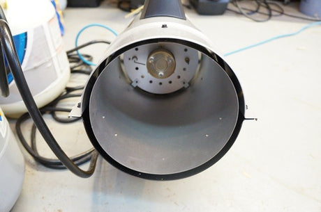 Close-up of DeWalt portable heater on a white surface with cables in the background