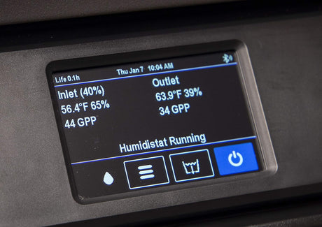 Digital dehumidifier display panel of a humidifier showing various readings and statuses.